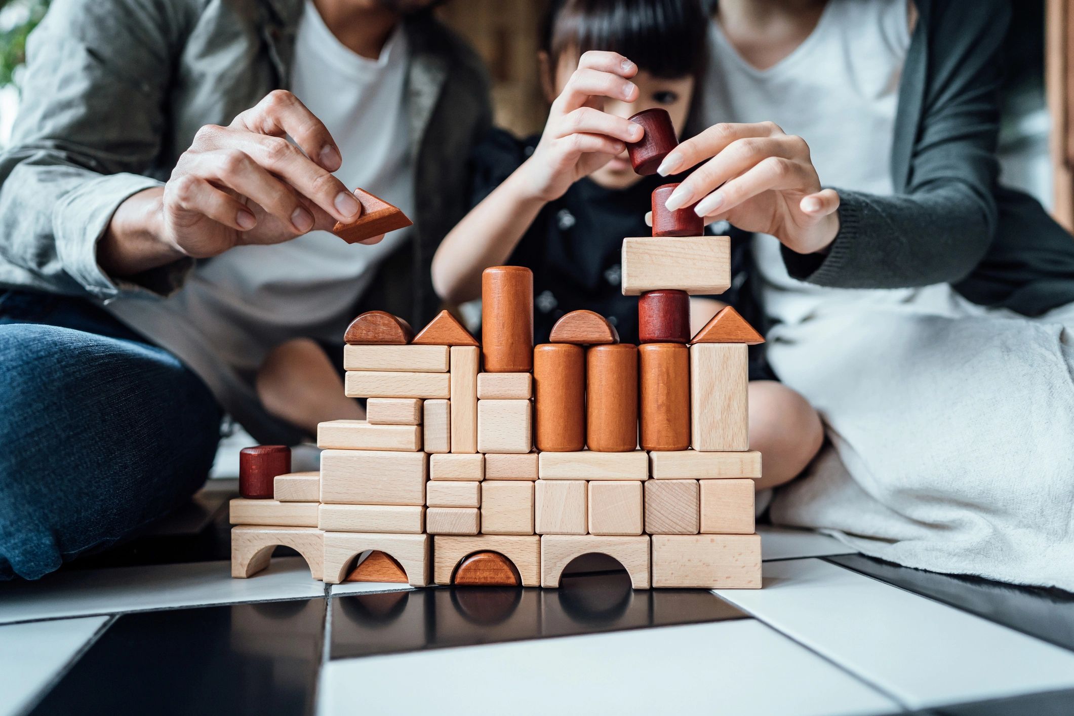 Child playing with wooden blocks during learning time