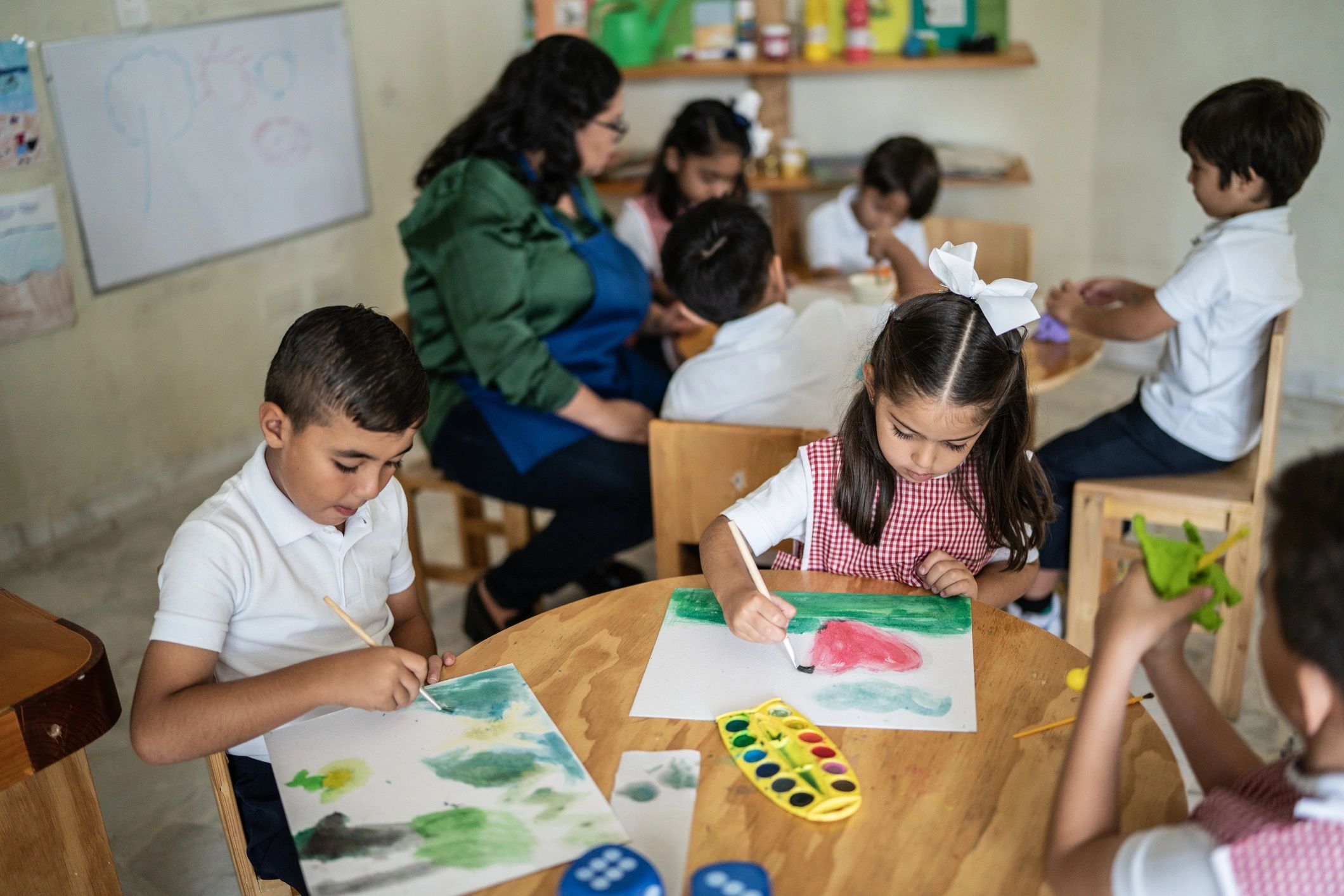 Children painting during an art activity in the classroom