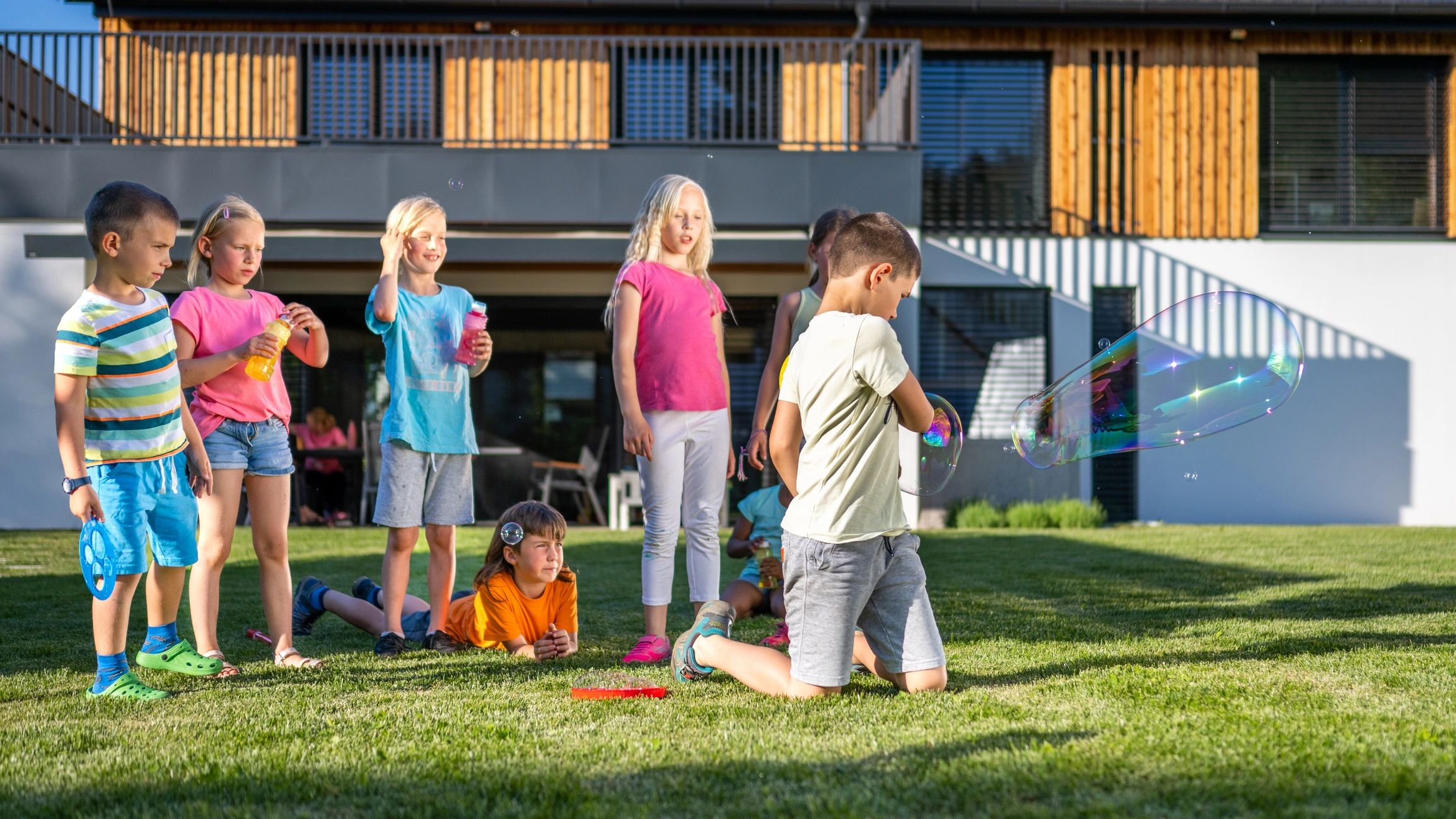 Children playing outdoors and blowing bubbles