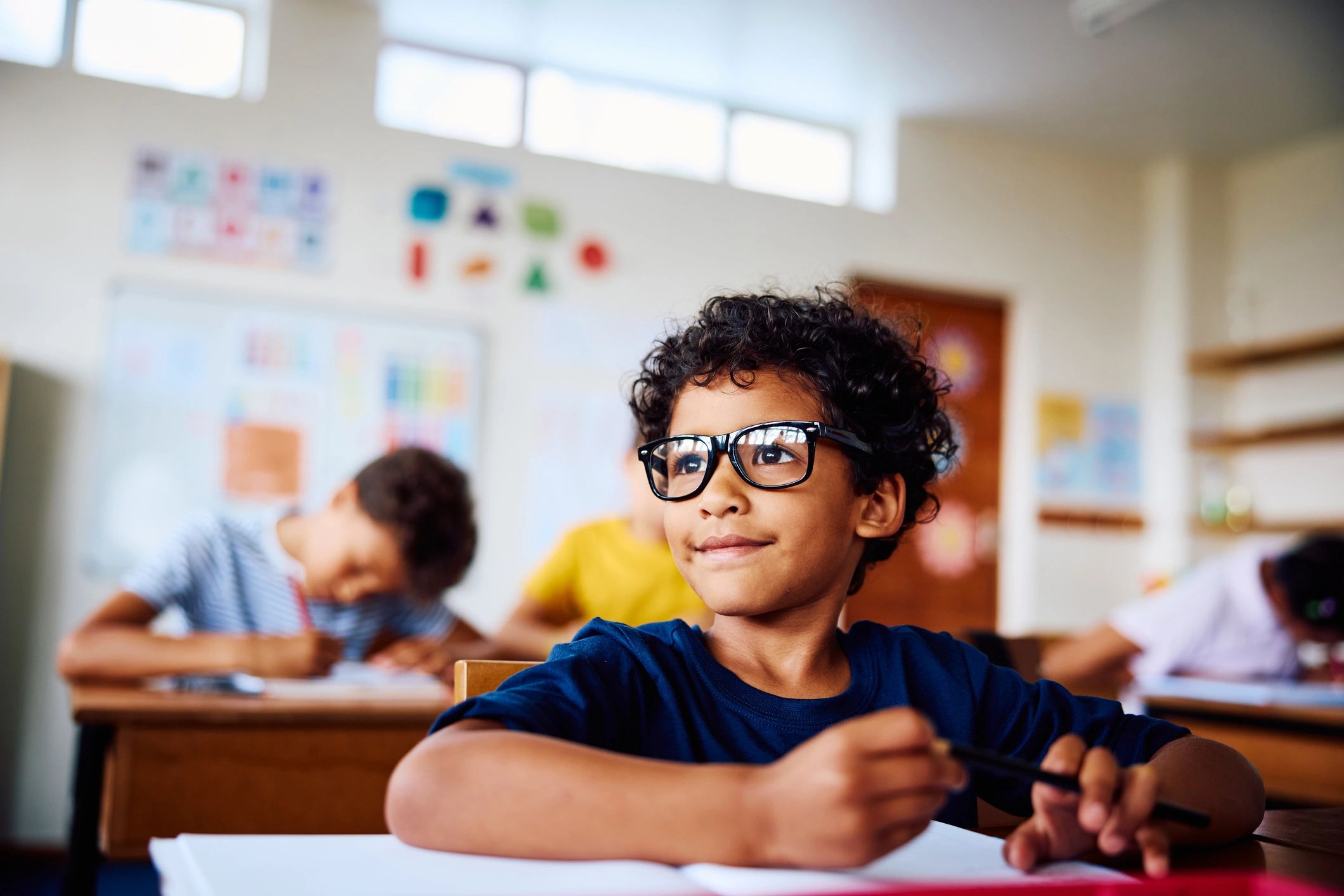 Child smiling in a classroom setting