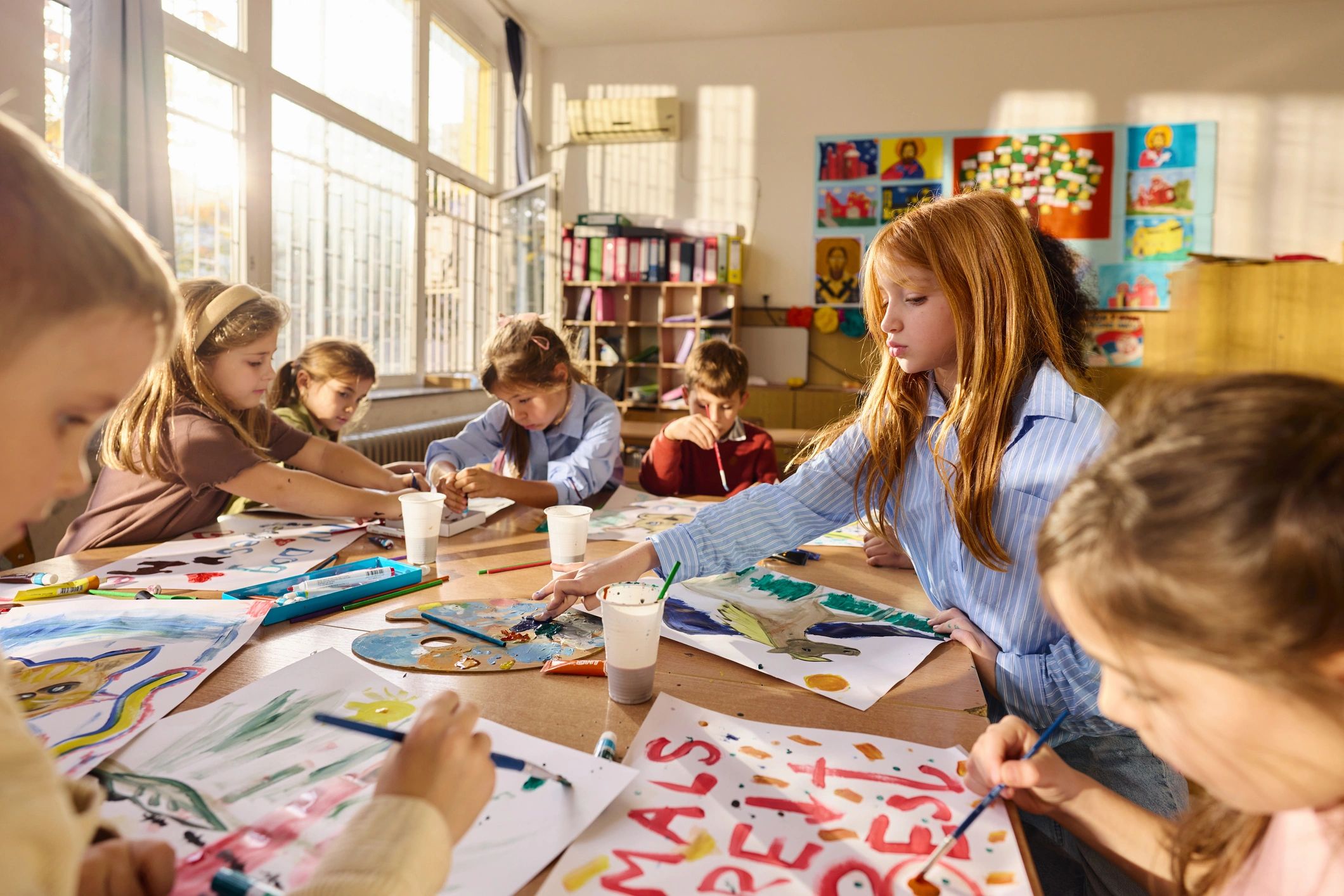 Children painting during an art activity in a classroom