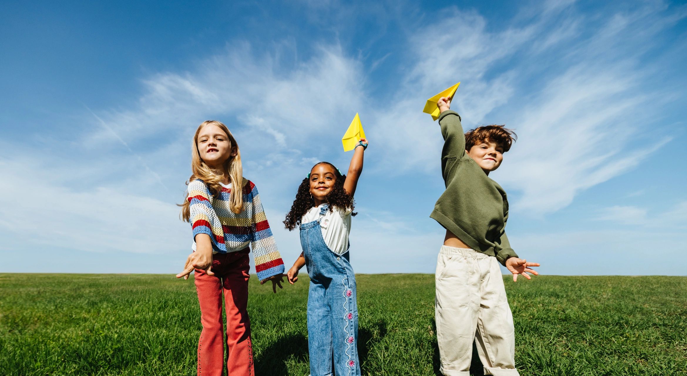 Children playing outside in a grassy field