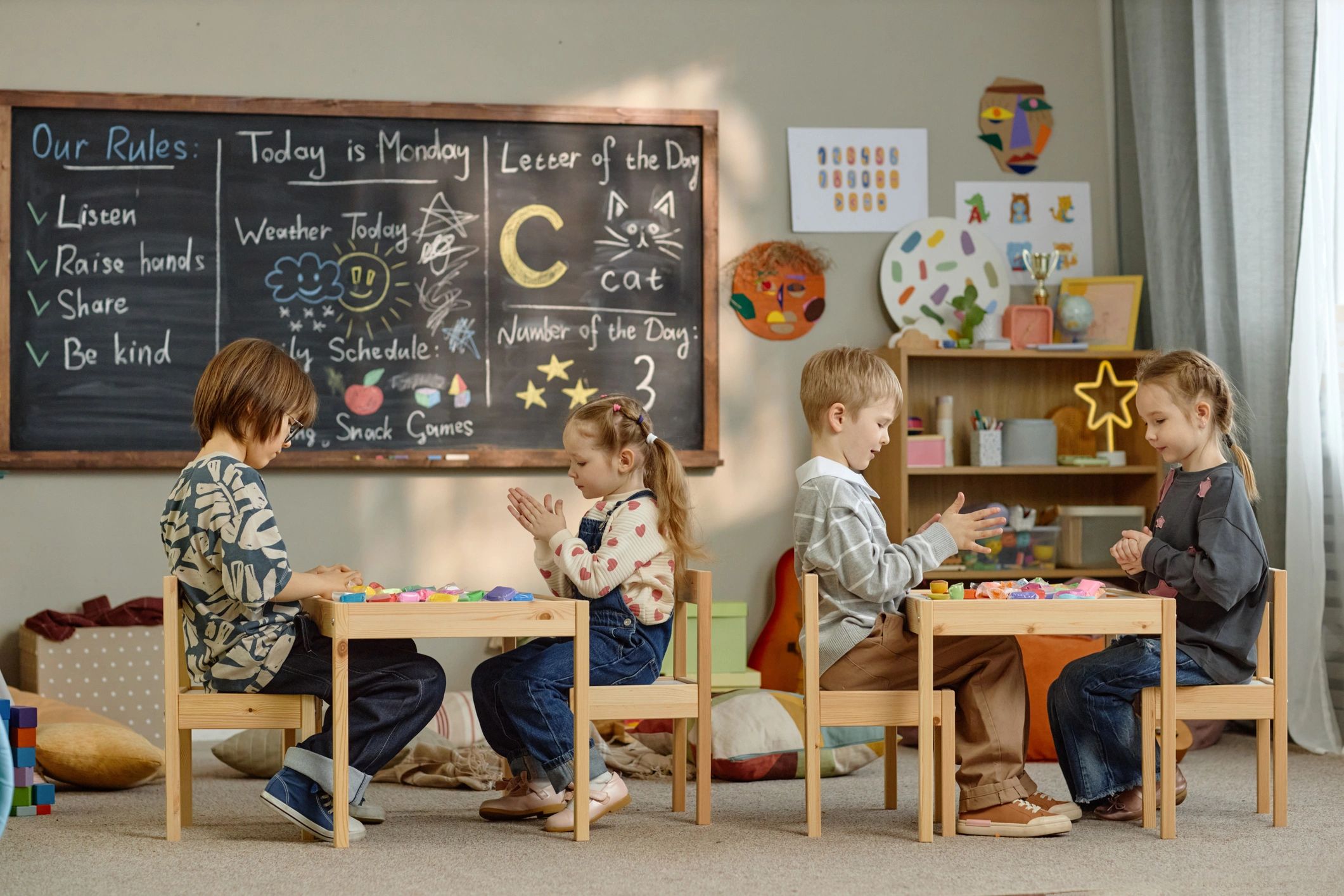 Children playing with educational toys at tables in a classroom