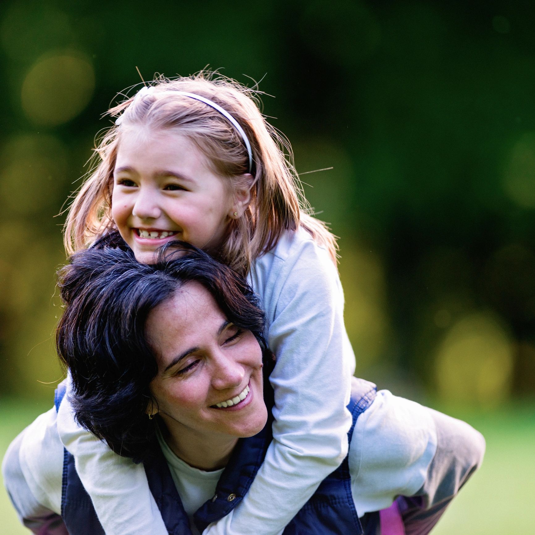 Smiling parent and child portrait representing family-centered care